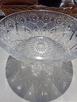 Side view of the large crystal fruit bowl showing floral carved details and clarity of material.