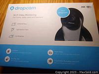 Box of Dropcam Wi-Fi Video Monitoring Camera displaying product image and features such as 30 second setup, HD video, live streaming, night vision, two-way audio, and cloud video recording.