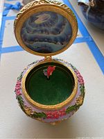 Opened view of Little Mermaid music box showing interior with Ariel figurine and cracked glass lid