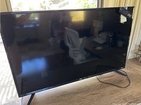 Front view of the TV showing the screen and TCL logo on the front bezel.