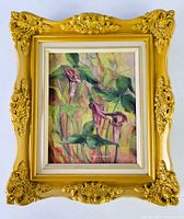 Frontal photo of the ornate gold carved frame with the floral oil painting inside.