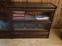 Front view of two-tier oak barrister’s cabinet showing glass doors and lower solid base.