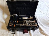 Open clarinet case showing all clarinet parts and accessories inside
