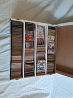 Top view of the baseball and hockey trading cards in white storage boxes showing cards stacked tightly.