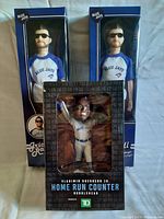 Three Blue Jays bobbleheads in original boxes: Vladimir Guerrero Jr. Home Run Counter and two Randall Grichuk figures.