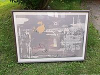 Framed print displayed on grass, full front view