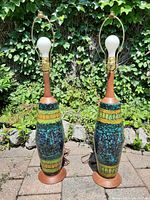 Pair of lamp bodies without shades in outdoor setting