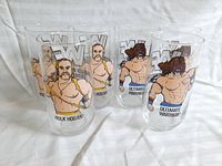 Six vintage wrestling collectible glasses, three featuring Hulk Hogan and three featuring Ultimate Warrior with WWF logos.