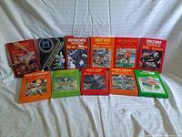 Overview of all eleven Atari 2600 game boxes arranged on white background.