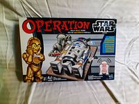 Front view of Star Wars Operation game box showing game title, characters, and art.