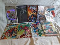 Nine vintage comic books displayed in two rows showing a variety of Marvel superhero titles including Fantastic Four, Spider-Man, Superman and Batman.