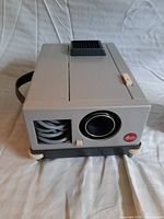 Front view of Leitz Wetzlar N24 Pradovit slide projector showing lens and cable compartment with Leitz logo.