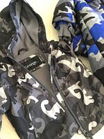 Close-up of black and grey camouflage fleece-lined jacket labeled George, size 6-12 months