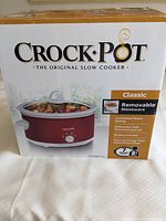 Photo of original Crock-Pot box showing the slow cooker and features including removable stoneware, capacity, and dishwasher safe information.