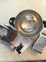 Betty Crocker hot air popcorn maker, colander, grater, and instruction manual