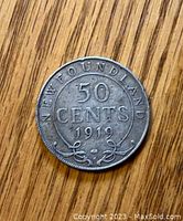 Front side of the 1919 Newfoundland 50 cents silver coin showing denomination and year.