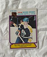 Front of 1980 O-Pee-Chee Wayne Gretzky hockey card showing player in Edmonton Oilers jersey skating on ice with hockey stick and helmet