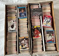 Top view image showing three long cardboard boxes filled with assorted hockey cards