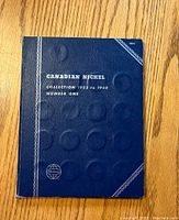 Blue folder cover titled 'Canadian Nickel Collection 1922 to 1960 Number One',' showing the branding and collection period.