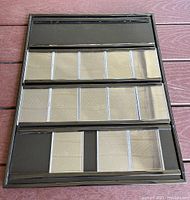 Front view of the framed sports card holder showing three rows of clear plastic pockets for card display.