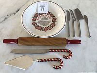 Photo showing the entire collection including cherry pie plate, cheese knives, rolling pin, pie server, and serrated knife.