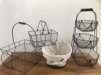 All four wire baskets shown together on wooden surface