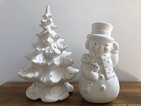 Photo of both vintage bisqueware ceramic pieces: Christmas tree and snowman together from the front.