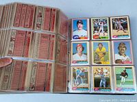 Photo showing a binder sleeve with 9 baseball cards per page, front and back views including player statistics and images, confirming cards from 1981 Topps set.