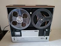 Front view of Sony TC-355 reel to reel tape recorder with loaded reels and control panel visible.