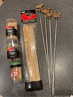 Image of various packaged bamboo forks, parasol picks, bamboo skewers, and four metal skewers with animal toppers