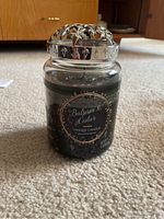 Large glass jar candle filled with dark green wax, label reads Balsam & Cedar by Yankee Candle. Candle appears slightly used.