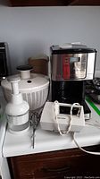 Photo showing Sunbeam coffee maker and several kitchen appliances including hand mixer, salad spinner, food chopper and juice container