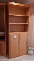 Full view of laminate display cabinet showing three open shelves and cabinet doors below.
