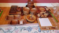 Overview of complete set showing wooden bowls, segmented trays, nut bowl, serving trays and boards including small utensils.