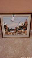 Full view of the framed artwork showing the rural scene with trees and cabin