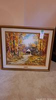 Overall view of the framed and matted oil painting depicting the rural scene, showing frame style and matting