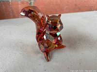 Close-up angled view of the red squirrel Swarovski crystal figurine showing detailed facets, rich colors, and the bushy tail.