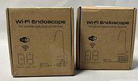 Photo of two original brown cardboard boxes for wireless Wi-Fi endoscopes, showing front with device illustration, Wi-Fi logos, and compatible device types iPhone, iPad, Android.