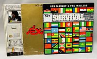 Front view of three Bob Marley & The Wailers vinyl album covers side by side: 'Babylon By Bus', 'Exodus - Movement of Jah People', and 'Survival'. Shows cover art and condition.
