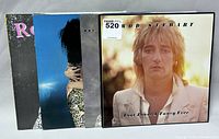 Four Rod Stewart record albums standing side by side showing front covers