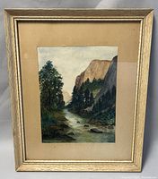 Frontal view of framed Lou Bowman watercolour painting showing river landscape with trees and cliffs