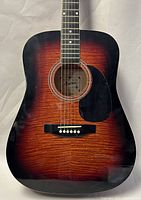 Front view of Montana MT-105-CB acoustic guitar showing sunburst finish and black pickguard