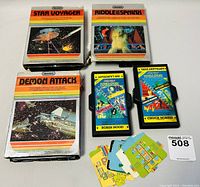 Three boxed vintage Imagic Atari video games and two additional double-end cartridges Robin Hood and Chuck Norris, with game cards.