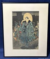 Front view of the vintage Japanese woodblock print featuring a man in traditional attire with a crowd in the background inside a black frame with white matting