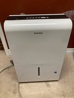 Front view of white Danby dehumidifier with visible brand logo and control panel on top.