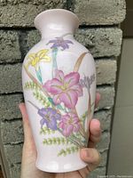 Front view of the vase showing detailed floral design with pink lilies and purple flowers.