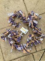 Top view of fabric tie garland showing purple, beige, and white fabric strips tied around a twine base.