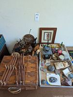 Full overview of the naturalist decorative collection showing carved wood quail, stoneware teapot, baskets, candles, rocks, incense, and framed art.