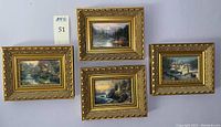 Overview of the 4 Thomas Kinkade art prints in gilt frames arranged together on a wall, showing size and design uniformity