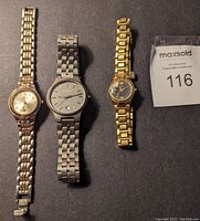 Three men's watches laid out next to MaxSold tag: Seiko two-tone with cream dial, Skagen titanium with gray dial, and Anne Klein gold-tone with dark dial.